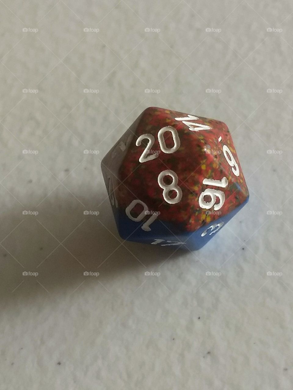 red twenty sided die used in tabletop role-playing games