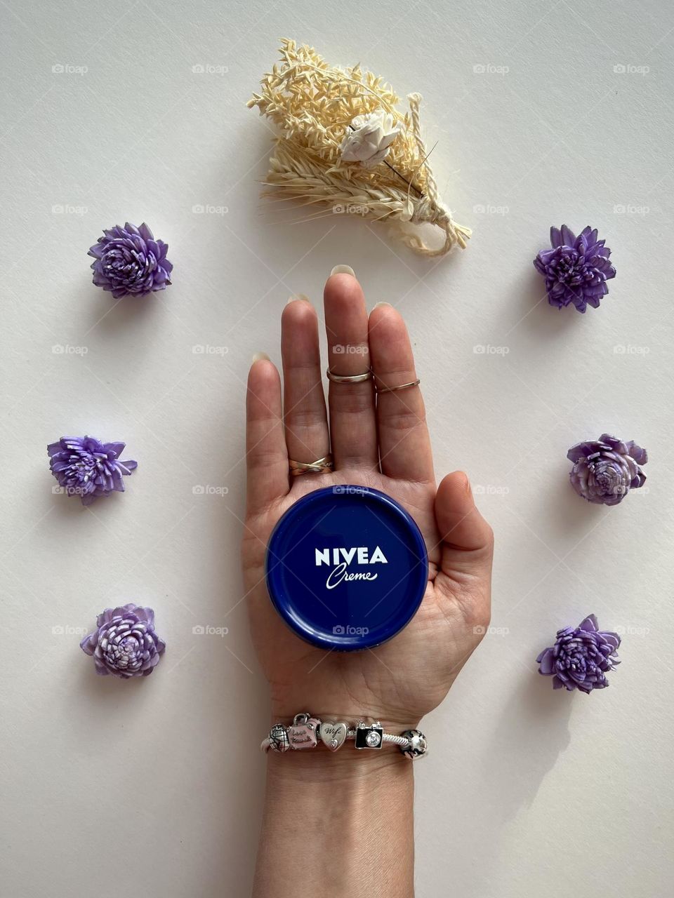 Famous beauty brand- Nivea cosmetic, hand holding the Nivea cream.