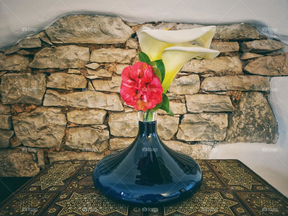 Flowers in a Vase. Stone wall background.