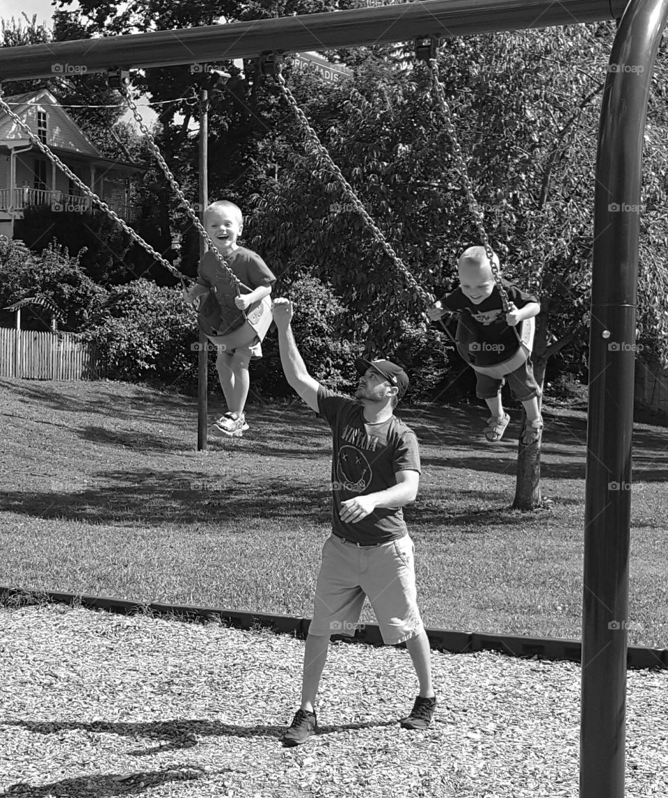 dad and boys on swings