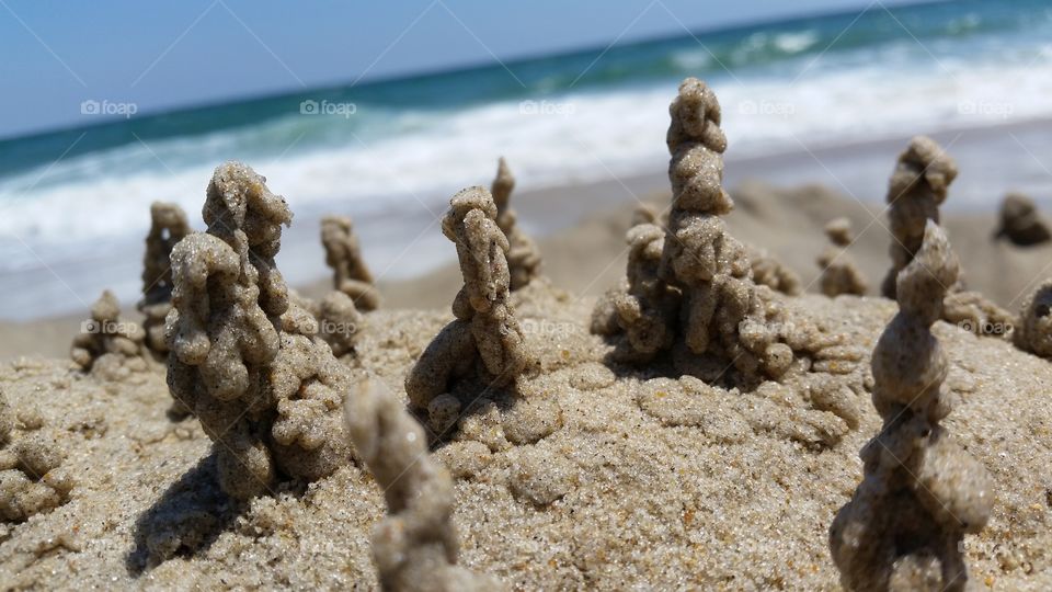 Tiny Village. Drip sandcastles at the beach