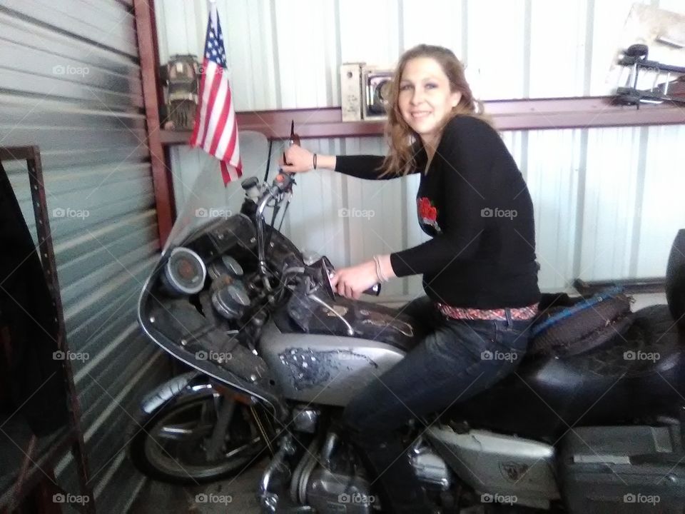 posing on motorcycle inside public storage unit