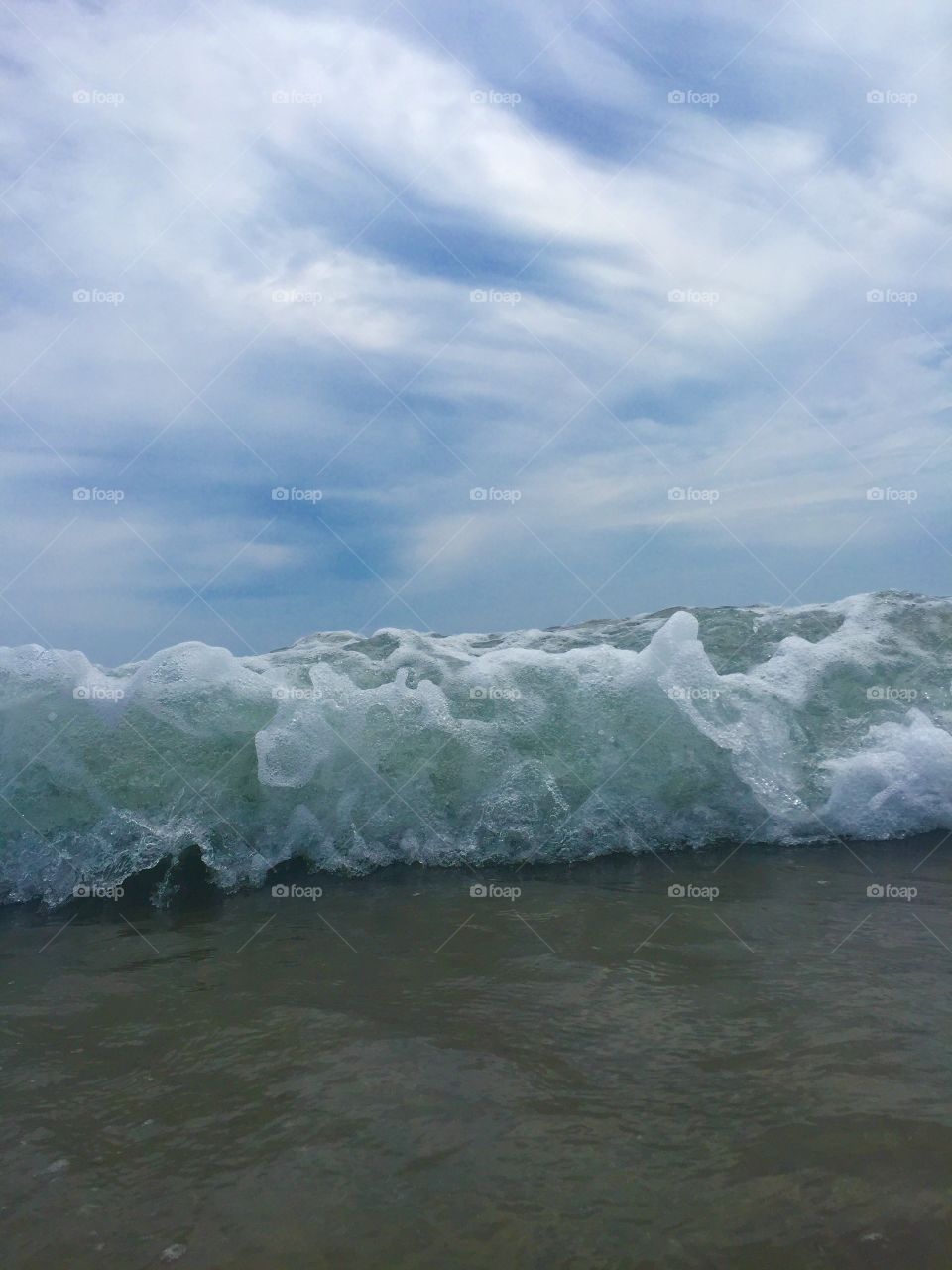 In the middle of a wave . Wave crashing down 