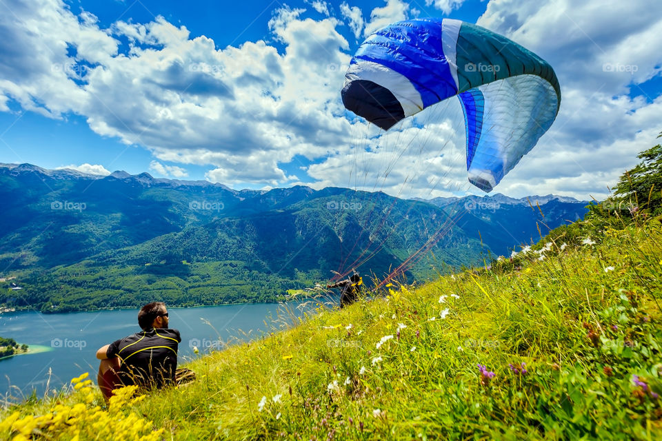 Man looking at person with parachute near sea