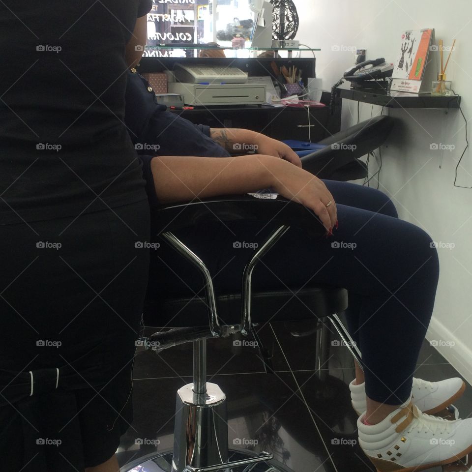 Adult female in beautician's chair at a beauty salon 