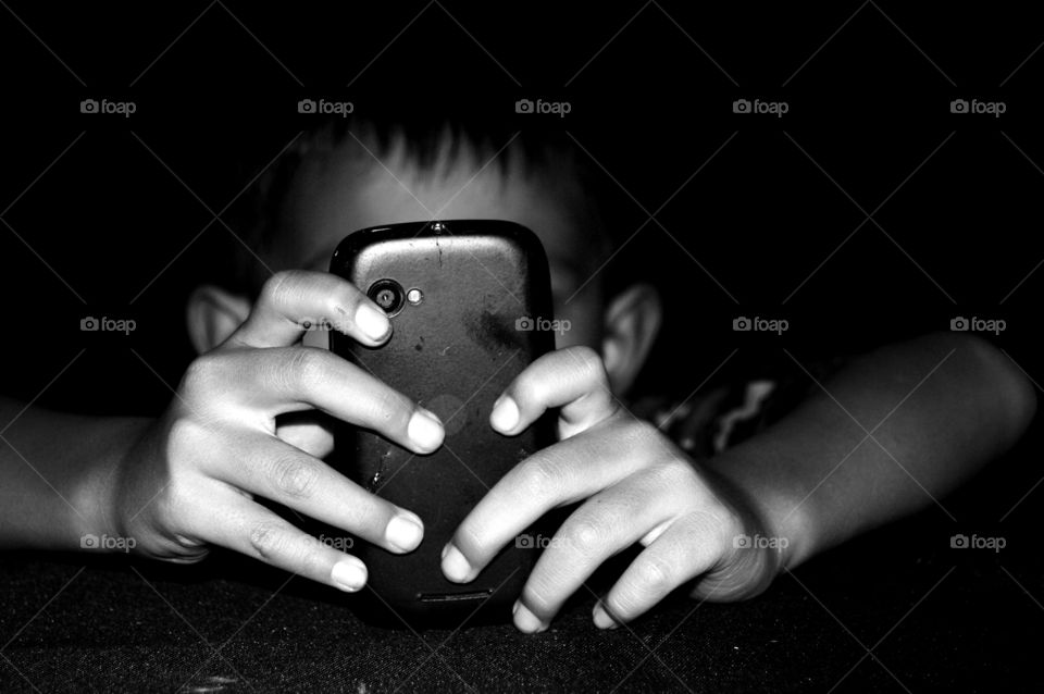 Online. kid using mobile phone