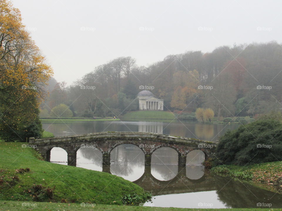 A bridge with reflection on lake at stourhead