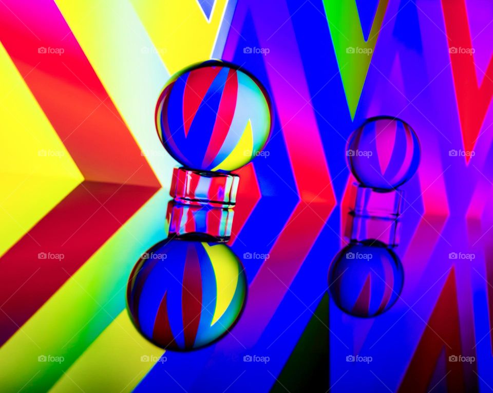 Colourful pattern reflected in 2 lens balls and mirrored
