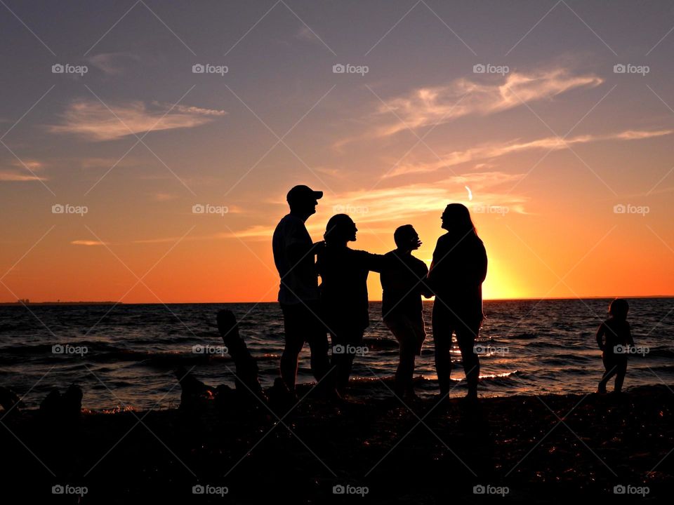 Magic Sunrise and Sunset - Friends converse about the latest news on the beach during a spectacular and colorful sunset