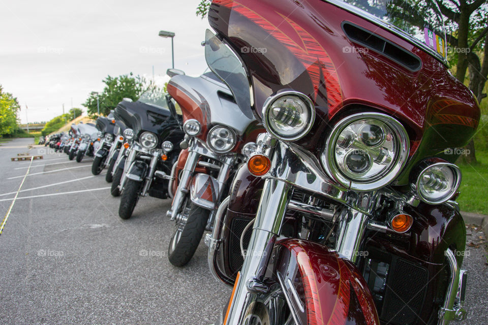 a large collection of motorcycles parked outside a hotel in Denmark.