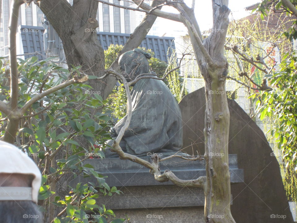 Buddha Statue and Trees in Asakusa Kannon, Sensoji Temple, Tokyo, Japan.