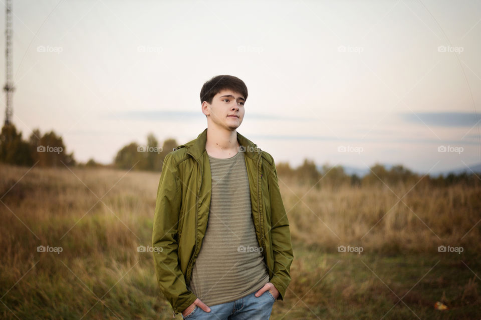 Portrait of a teenage boy in field