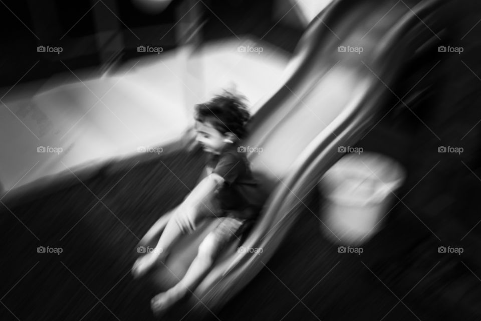 Yippee . Child on a slide in black and white