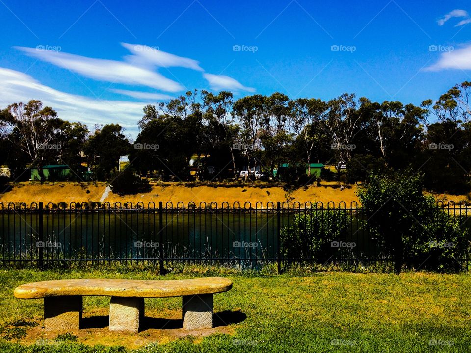 The bench by the gated river. River at Dunalley, Tasmania