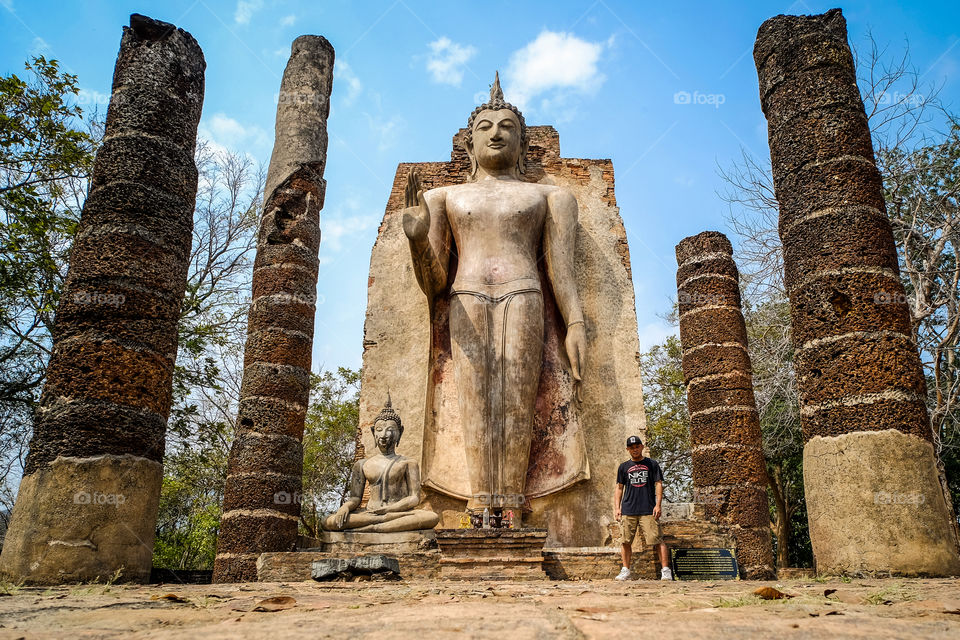 The oversized Buddha statue in the Sukhothai Heritage Park in Thailand, in order to go there, I ride a bicycle to sweat!