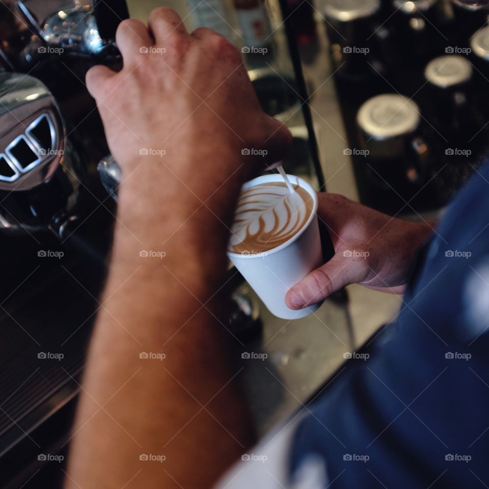 Man pouring coffee in cup