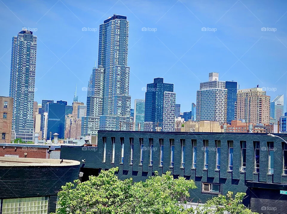 A beautiful panorama shot of LIC, Queens taken from the „Greenpoint“, Bklyn side of the „Pulaski Bridge“ while ascending the metal staircase to the pedestrian lane on a bright sunshiny day in early July of 2022. Hypnotic Productions