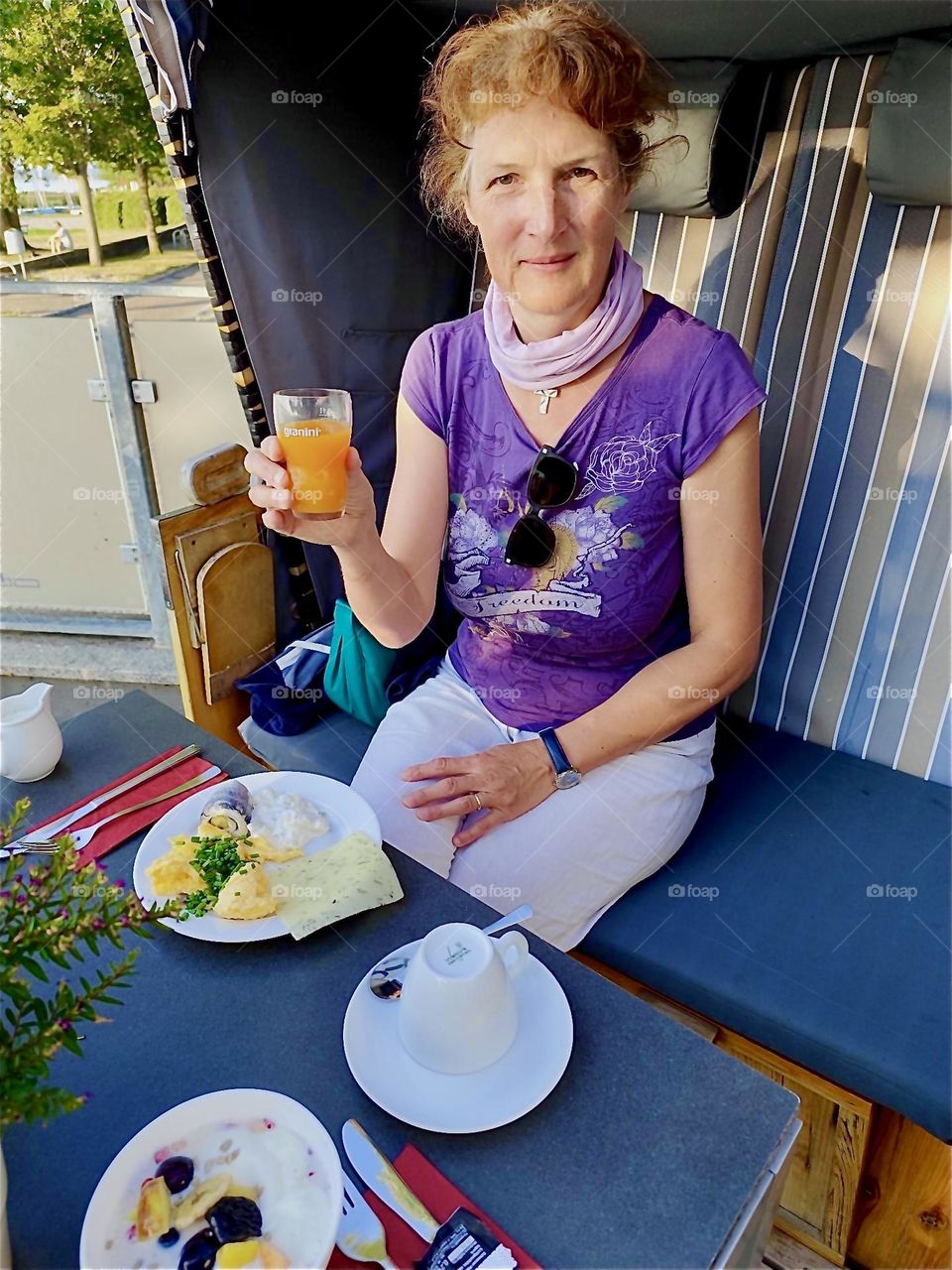 Sitting down for a snack is a welcome pastime here in “Dranske” on the island “Rügen” in the “Baltic Sea” in “Western Pomerania”, Germany when reclining in this individual beach basket with a bench and table. 2024. Hypnotic Productions