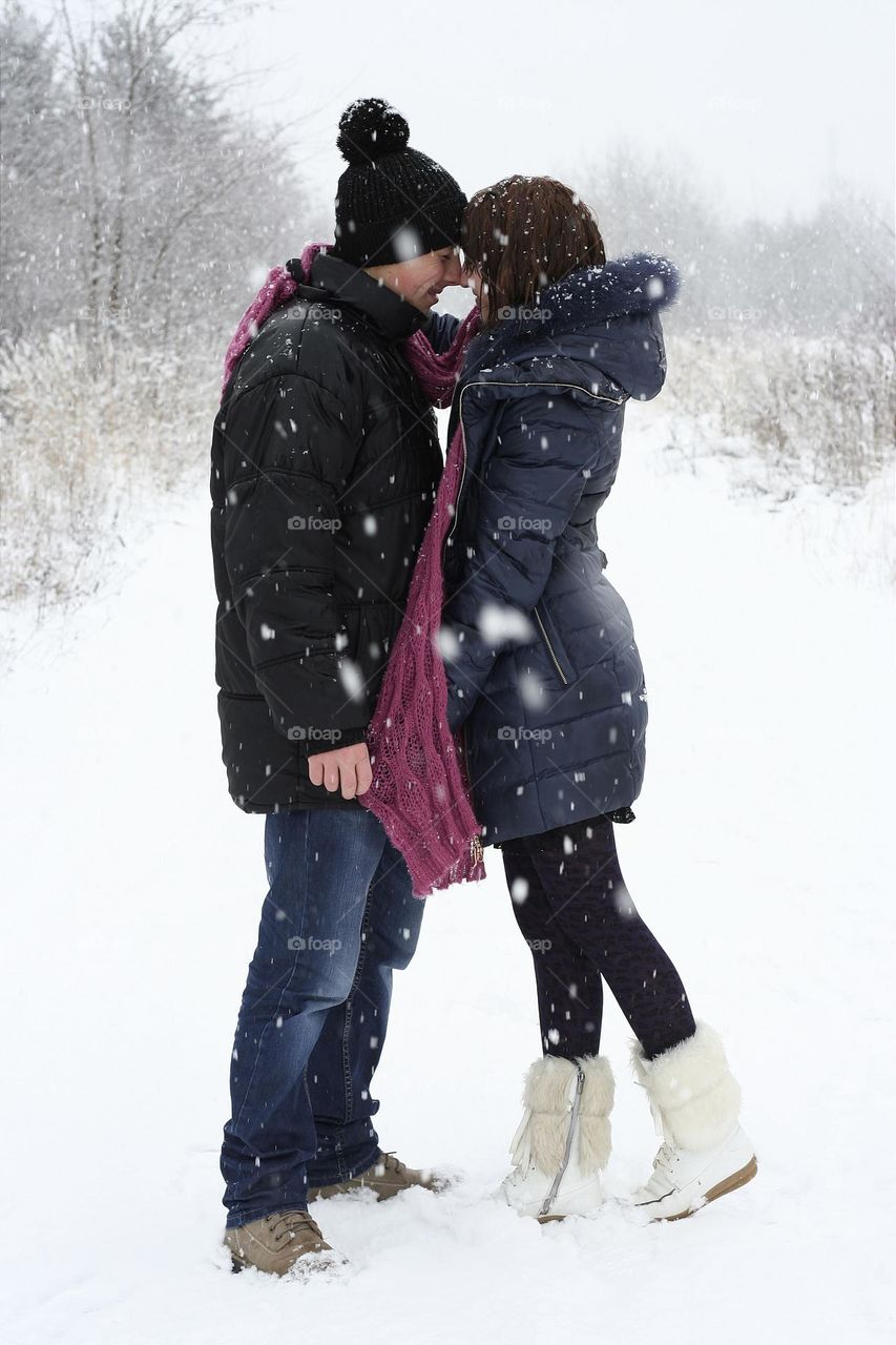 a young couple basks in themselves both on a winter day and in their mood