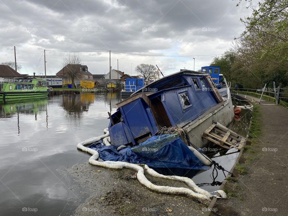 A sinking boat on a canal