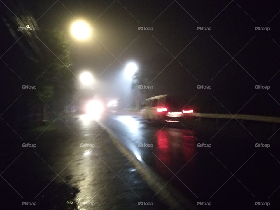 Another rainy and foggy evening with cars on the road.