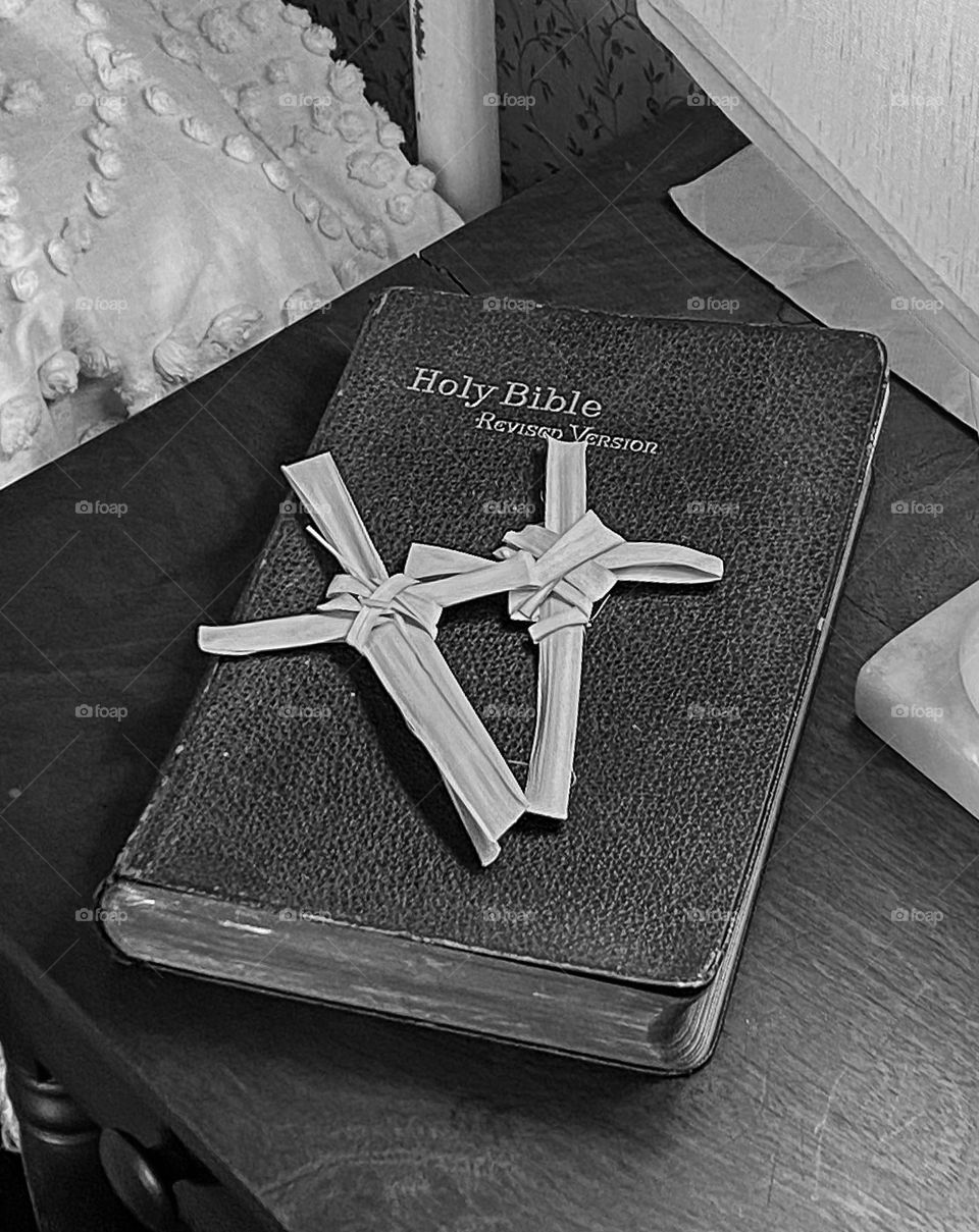 Easter traditions mission - black and white of s bible with palm leave crosses on Easter 2023 