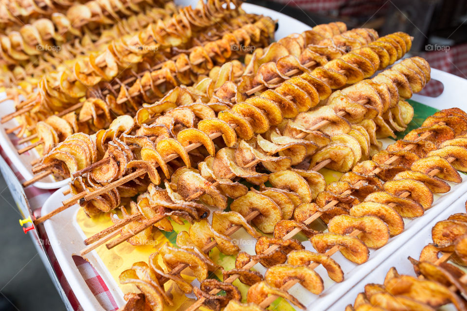 Fried potato chips on a skewer