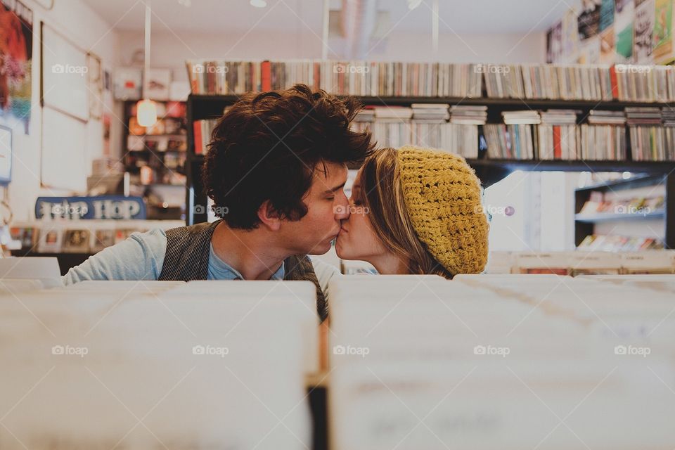Two couple kissing in book stall