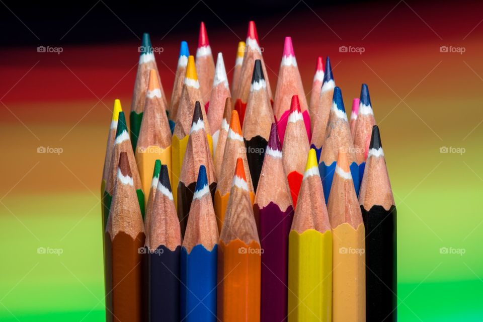 Colored pencils against multi colored background