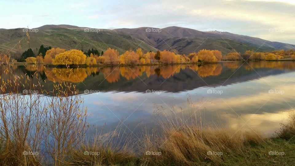 Reflection of mountain and autumn trees