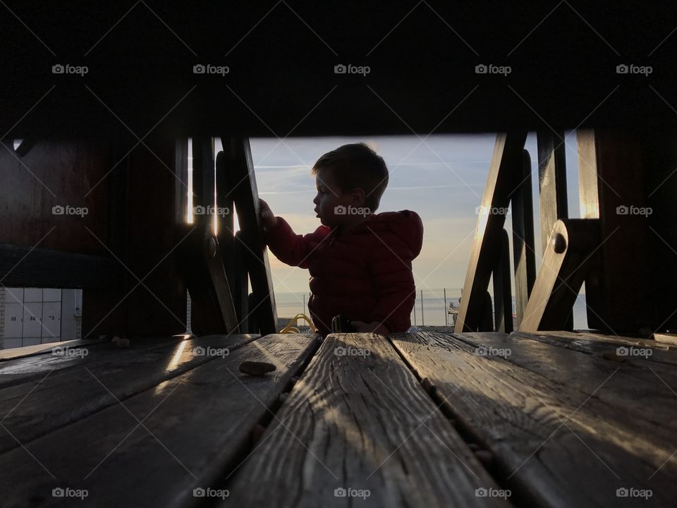Silhouette of little boy standing at staircase
