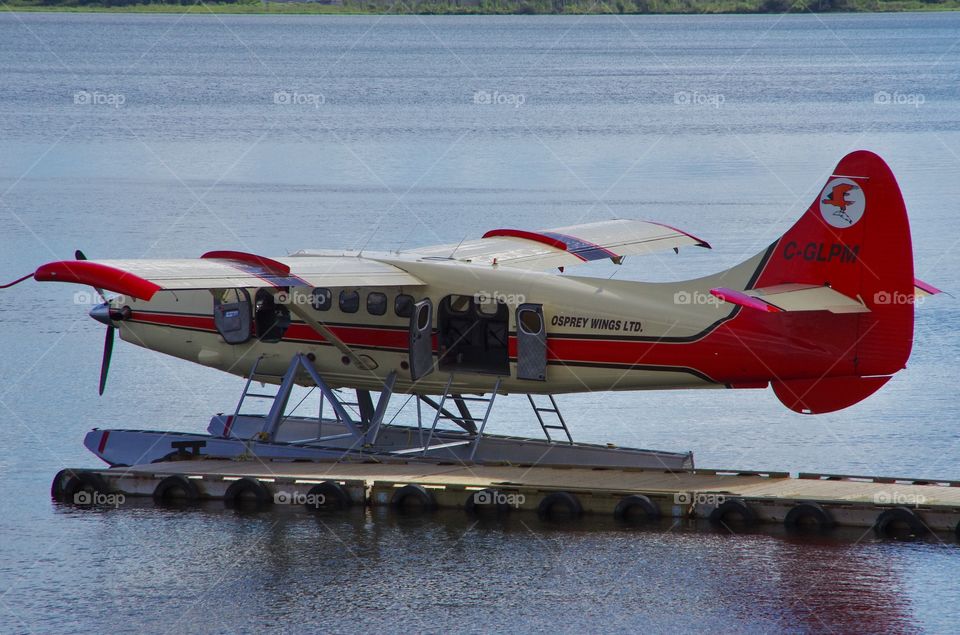 Exterior daylight.  La Ronge, SK, CA.  A single Otter floatplane awaits passengers.