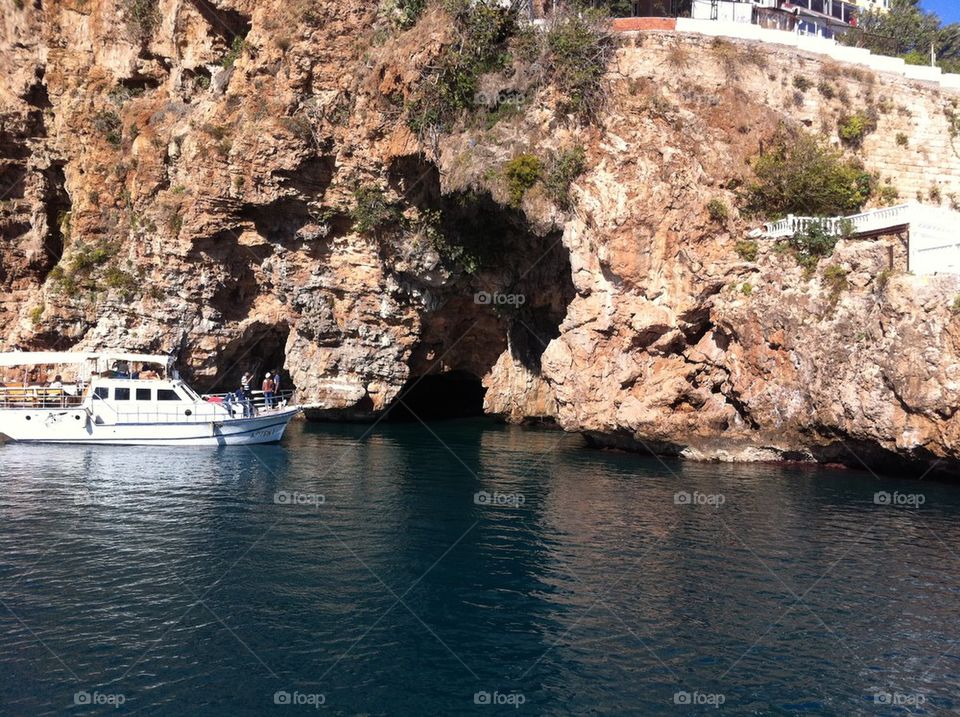 boat under a cliff