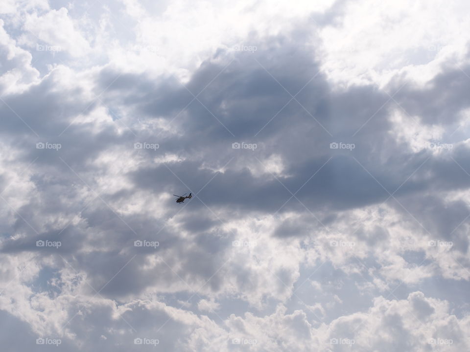 Low angle view of helicopter flying in sky