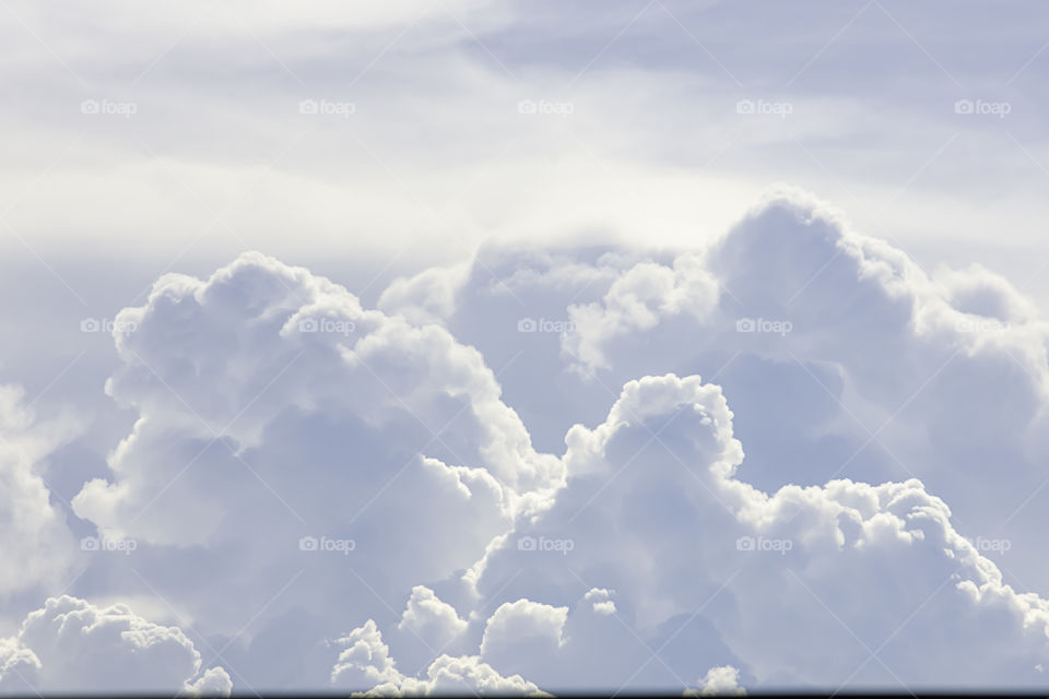 The beauty of the sky with clouds and the sun in summer.