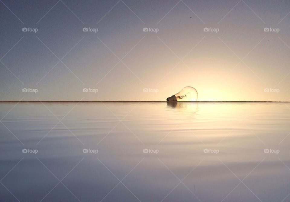 lamp in front of a sun at sunset