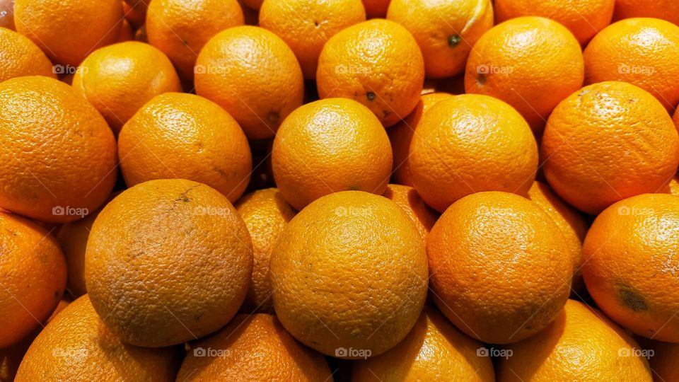 A bunch of fresh orange fruit at the market.