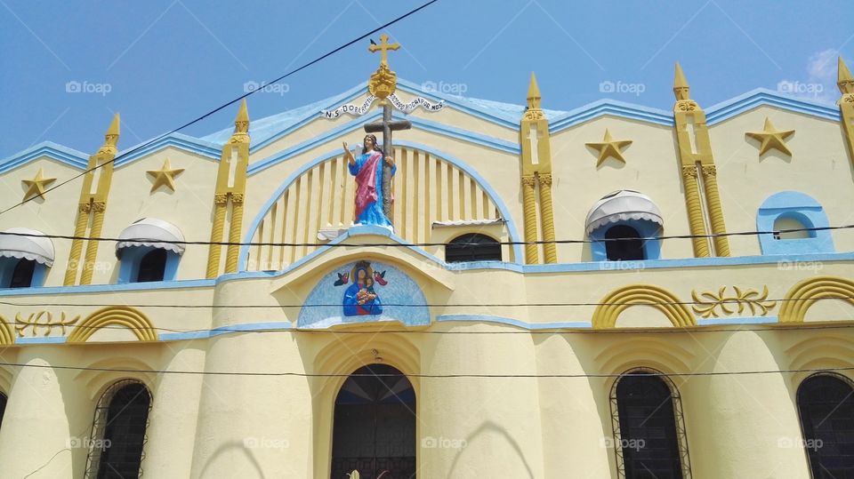 Yellow church with sculpture of Christ in the Brazilian province city.