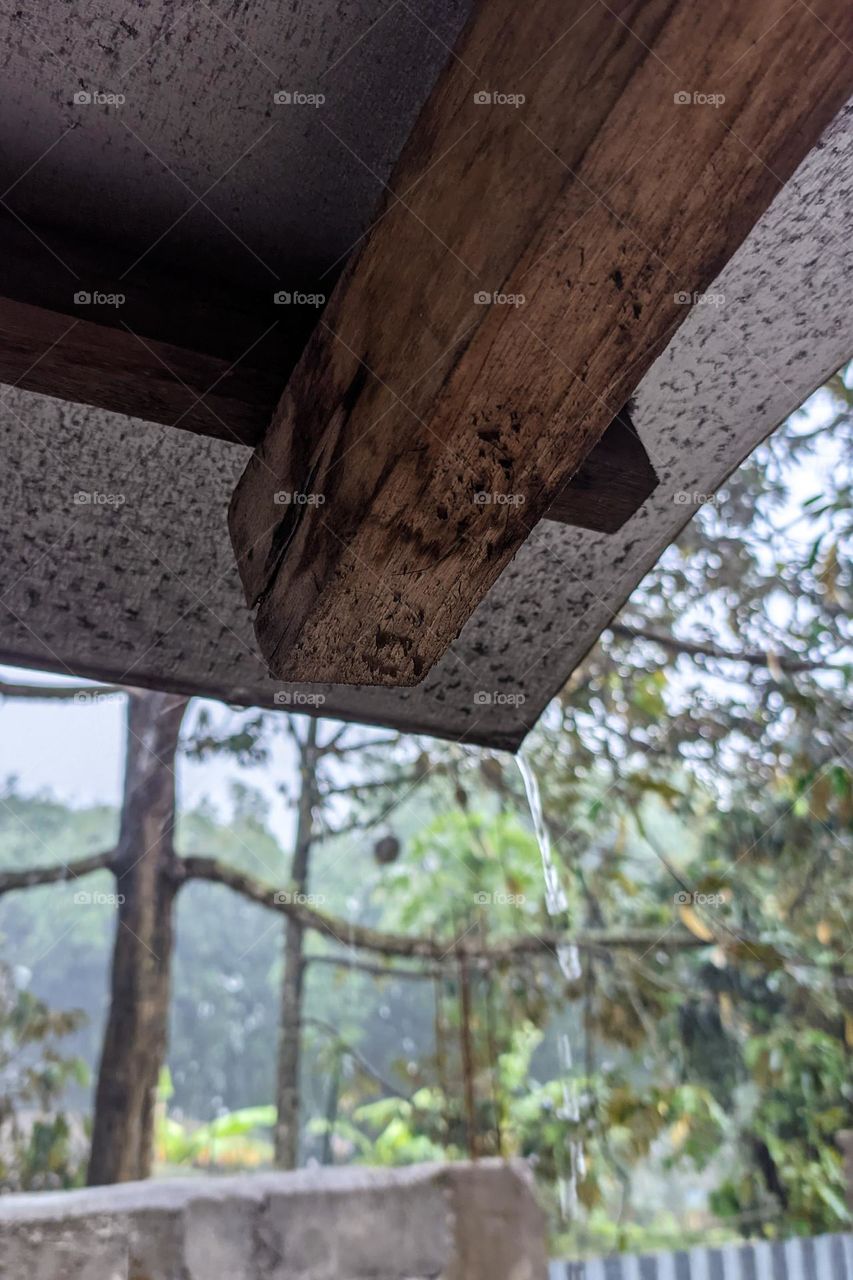 House canopy with water pouring out during heavy rain in low angle view