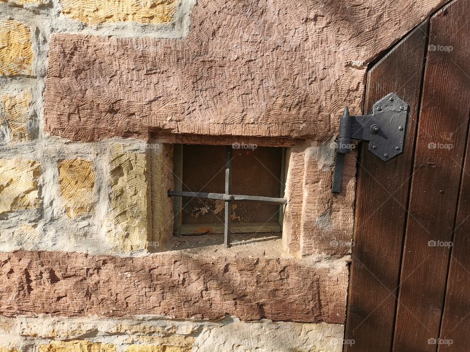 Historic building with little window and a huge door