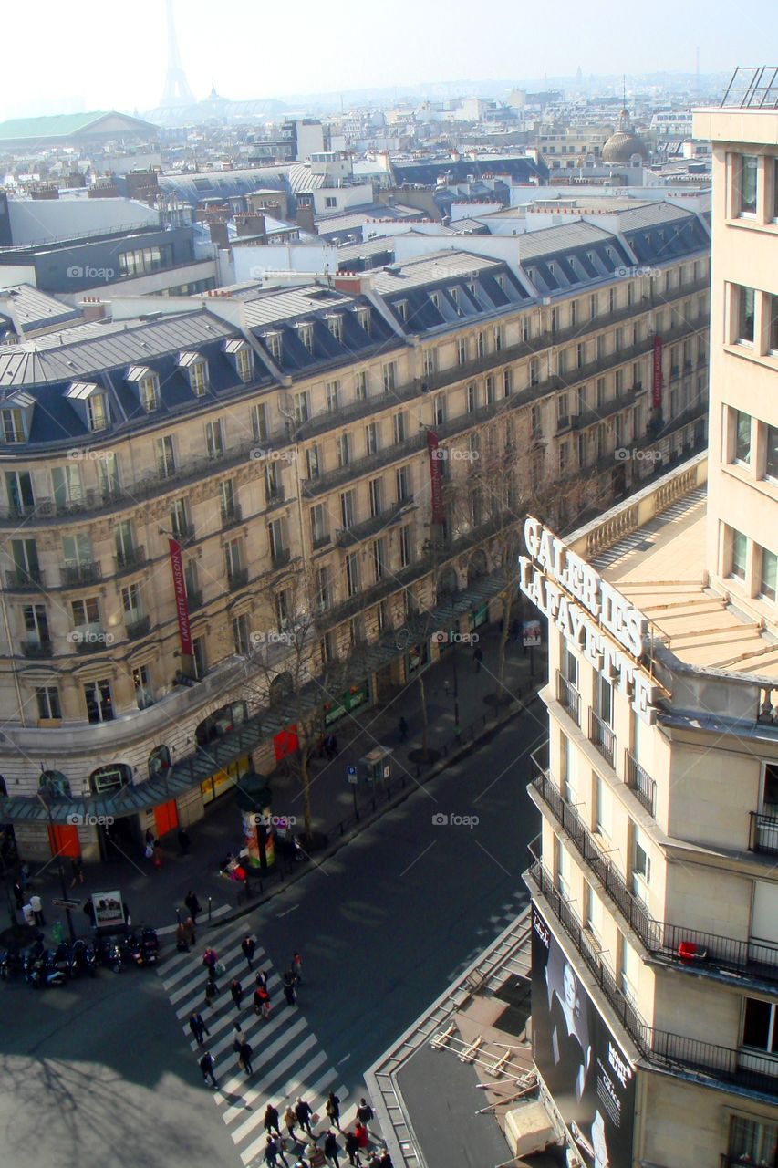Galeries Lafayette in France, buildings and roofs and people crossing a zebra crossing
