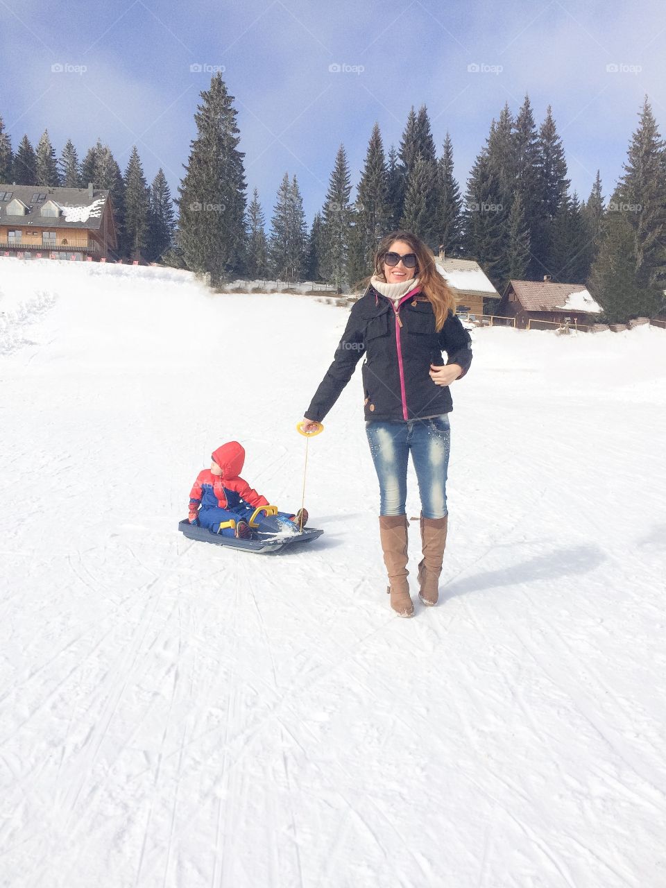 Mother with her child on snowy landscape