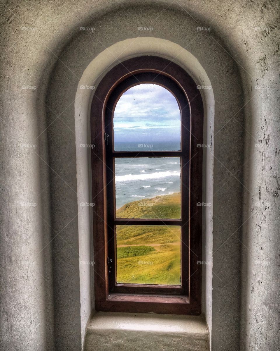 Looking at the see through the lighthouse window.