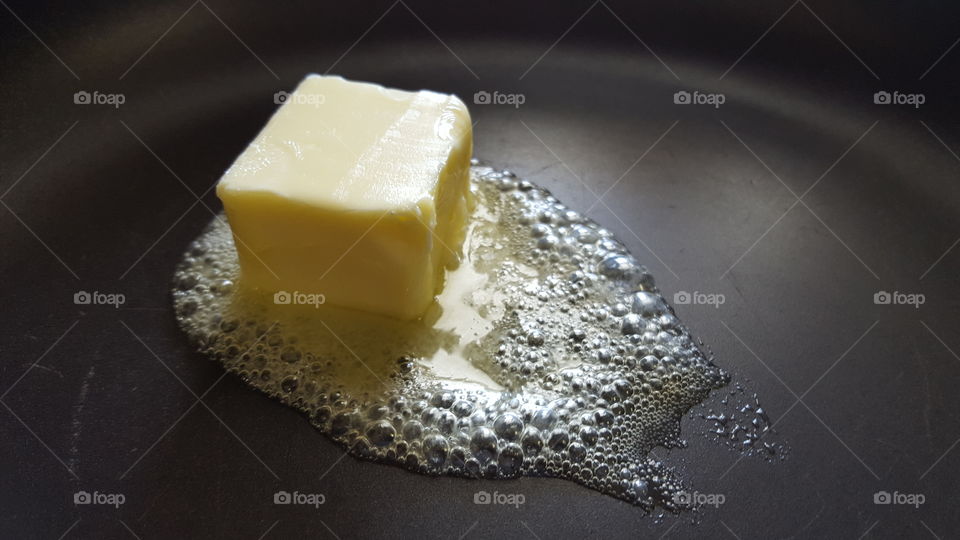 Close-up of butter melting On frying pan