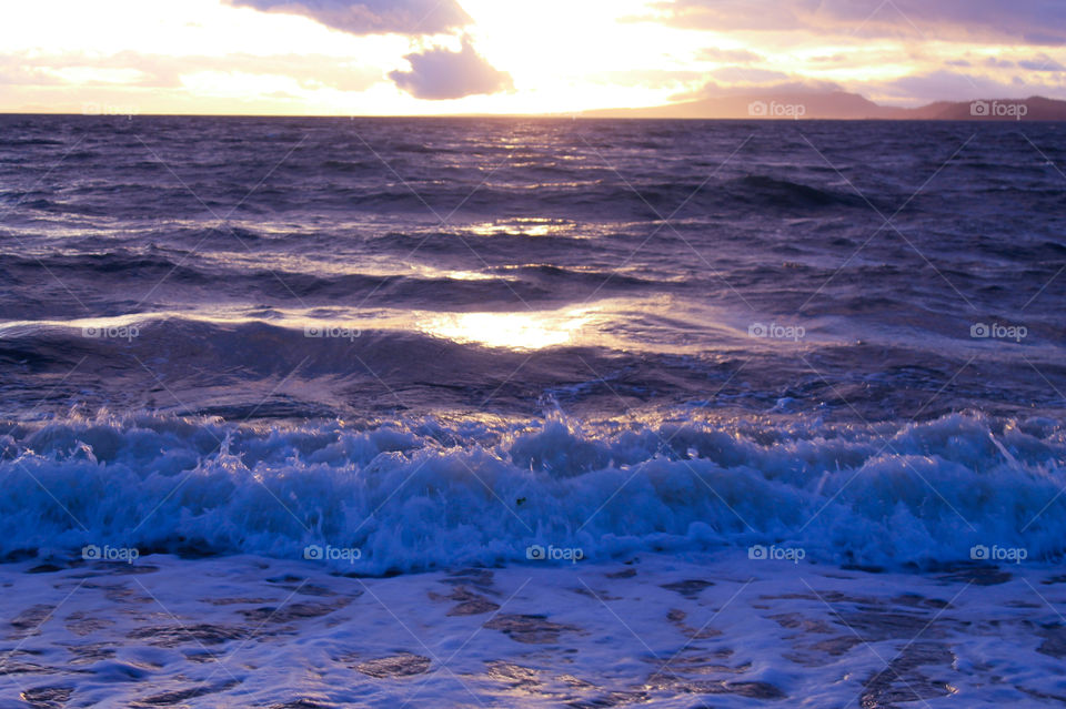 Day or Night? Even though this photo was taken  at 11:14 am, 10 Jan 2019, the sun had only been up for exactly 3 hours. The sun was low in the sky & shone between some clouds creating beautiful shadows & reflected light on the waves. 