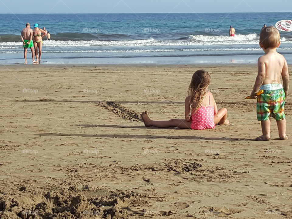 little girl playing on a sandy beach