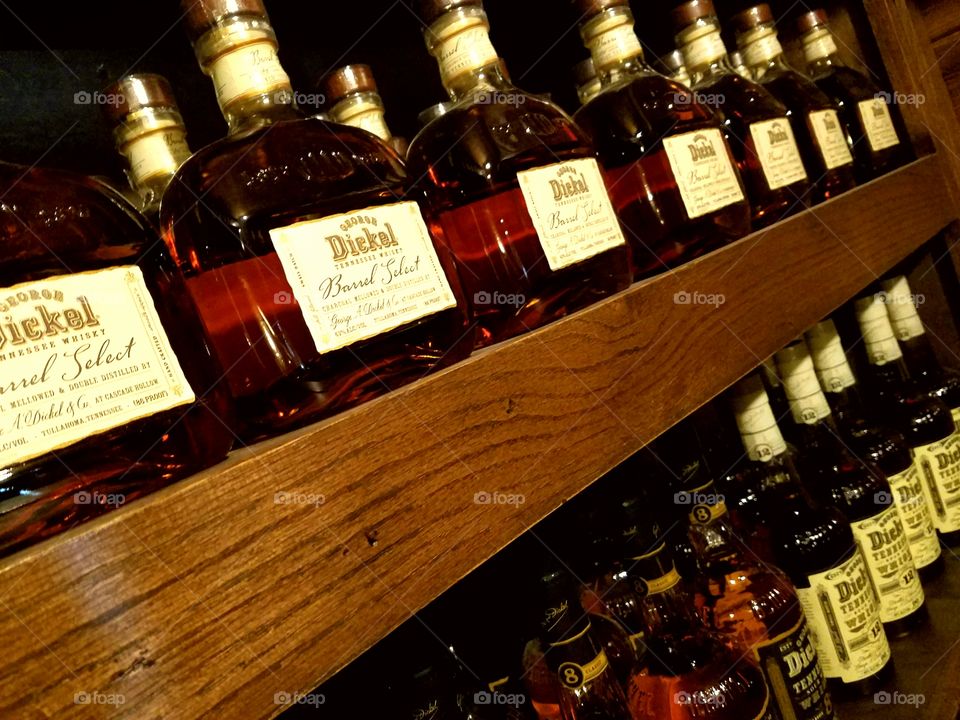 Bottles of Whisky on Wooden Shelf
