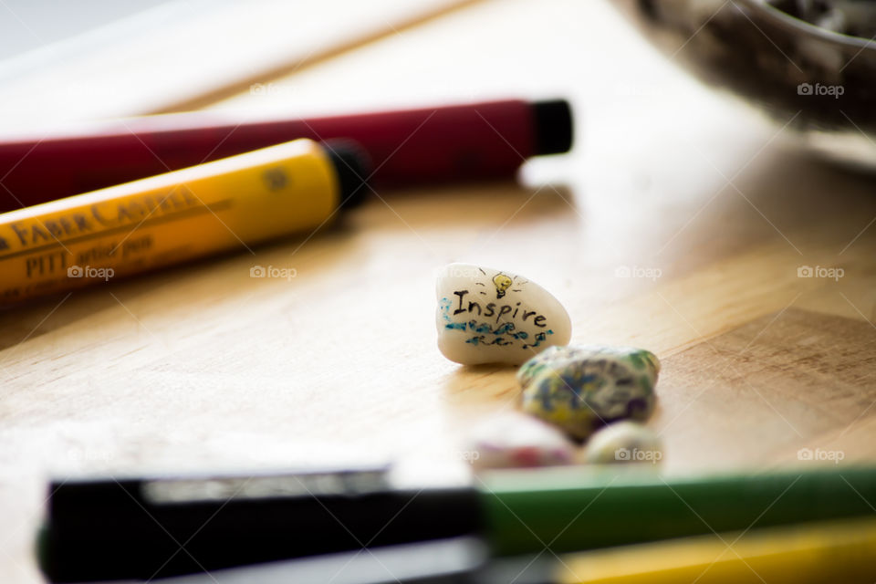 Inspire creativity in the little things message drawn on tiny stone with Faber Castell PITT artist pens 