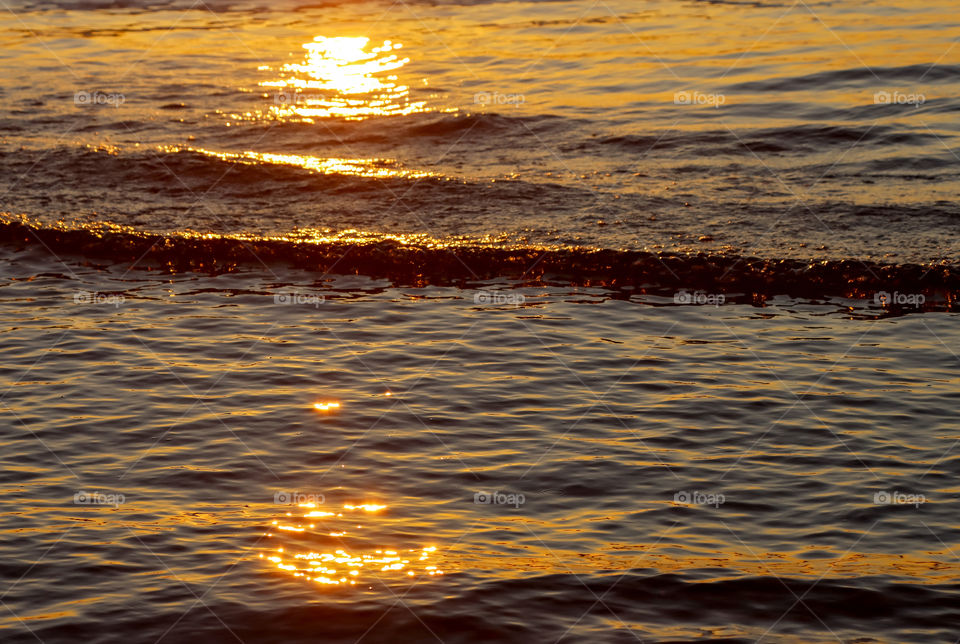 Sun reflection on sea surface at sunset