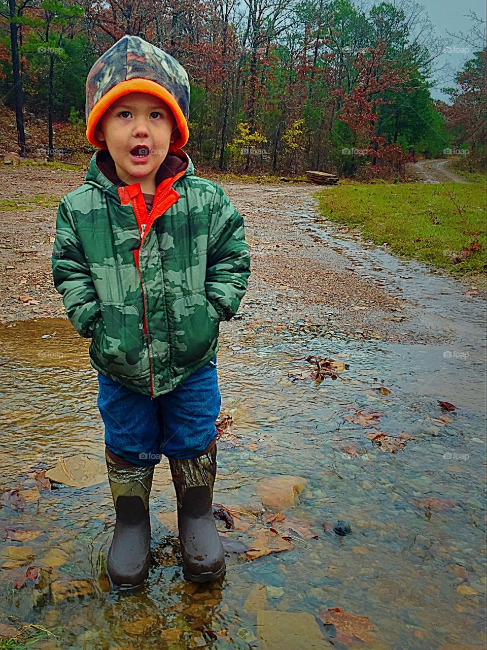 Boy playing in puddles